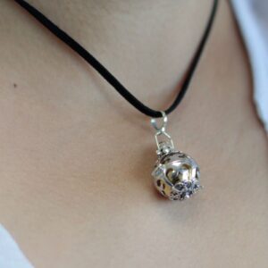 Elegant silver angel bell with intricate detailing, symbolising dreams and mindfulness.