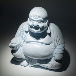 Sky blue Laughing Buddha lamp with a round stand and crackle finish.