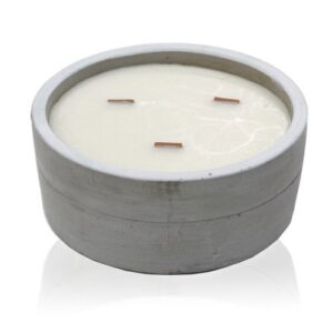 Large round concrete candle with wooden wick in patchouli and dark amber scent.