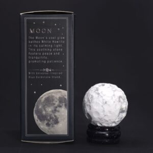 White Howlite planet on a Solar Goldstone stand, promoting peace and tranquility.