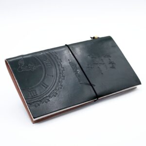 Handmade green leather journal with embossed design and wrap-around band.