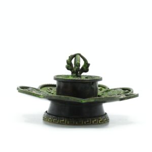 Handcrafted brass incense holder with Eight Auspicious Symbols in verdigris finish.