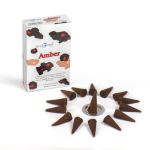 Aromatic amber incense cones for a calming atmosphere.