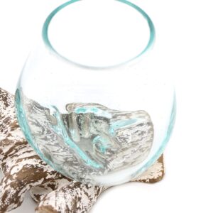 Small bowl made of molten glass on a whitewash wooden surface.