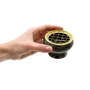 Handmade yellow charcoal incense jar with golden patterns for rituals.