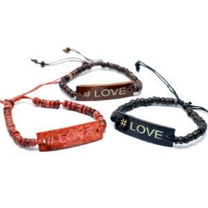 Coco beaded stretch bracelet featuring the slogan #Love in a natural setting.