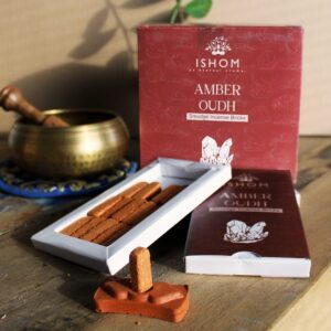 Natural incense smudge bricks and terracotta burner with amber wood scent.