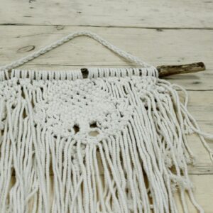 Handcrafted macrame wall hanging with a boho design for home decor.