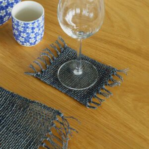 Natural seagrass coasters in charcoal with fringe detailing for stylish table settings.