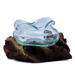 Molten glass wavy bowl resting on natural gamal wood, showcasing organic design.