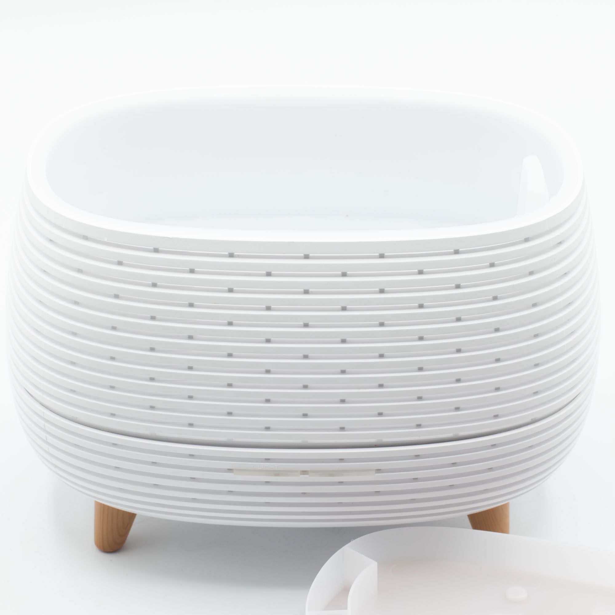 Futuristic ribbed aroma diffuser with wood-effect top and colour-changing light.