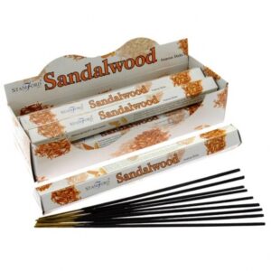 Sandalwood incense sticks in a stylish holder, perfect for relaxation.