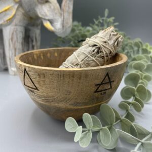 Wooden smudge bowl featuring four elemental designs, perfect for rituals and offerings.