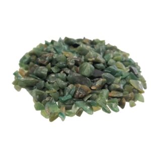 Bulk green aventurine gemstone chips in a natural setting.