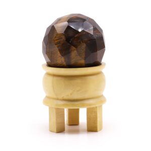 Tigereye gemstone faceted healing ball with wooden stand for mindful living.
