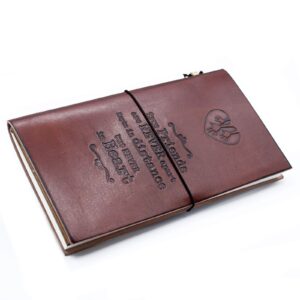 Brown handmade leather journal with embossed design and wrap-around band.