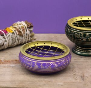 Handmade purple charcoal incense jar with golden patterns for rituals.