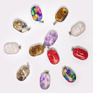 Assorted gemstone chips and shells in a steel cased pendant.