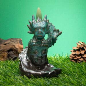 Backflow incense burner featuring a dragon above a serene Buddha statue.
