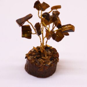 Mini gemstone tree made of Tiger Eye stones on a wooden base.