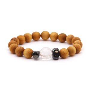 Cedarwood Crown Chakra Bangle with Clear Quartz gemstone on display.