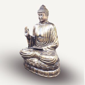 Large antique gold Buddha statue teaching on a lotus flower base.