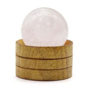 Clear quartz gemstone sphere with a stand, perfect for home decor.