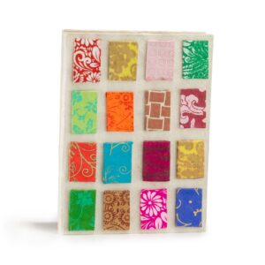 Mini notebook with bright tile patterns on a natural-toned cover.