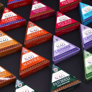 Jumbo Golden Nag Benzoin backflow incense cones with smoke cascading downwards.