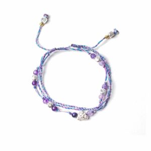 Temple String Bracelet featuring silver charm and beads for protection and fortune.