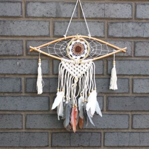 Handmade macrame dream catcher featuring an Evil Eye design for protection.