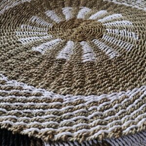 Round seagrass basket in white and tan, perfect for home decor and storage.