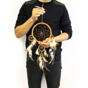 Large round dream catcher in cream, coffee, and chocolate colours with feathers.