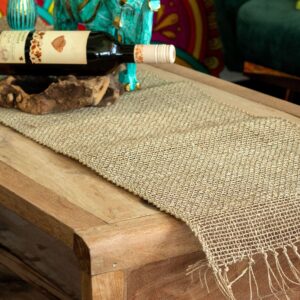 Handwoven seagrass table runner with fringe, perfect for rustic home decor.