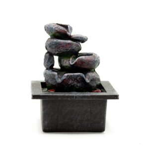 Cascading tabletop water feature with rustic pots and flowing water.