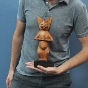 Handcarved wooden yoga cats in a serene pose, perfect for home decor.