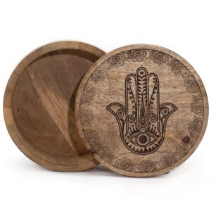 Black engraved Hamsa design on a big round box for home decor.
