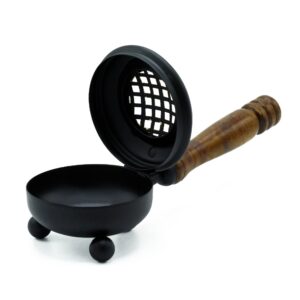 Cast-iron incense burner with gold detailing and wooden handle.
