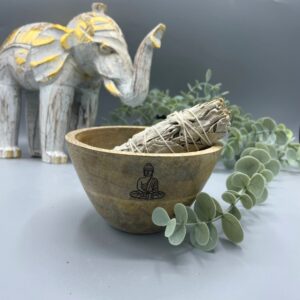 Wooden smudge bowl featuring a Buddha design, ideal for rituals and offerings.