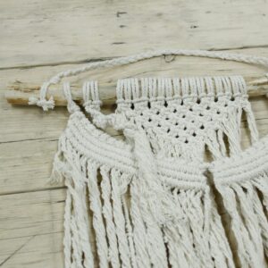 Handcrafted macrame wall hanging with a boho design for home decor.