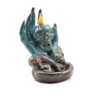 Skull in Hand backflow incense burner with cascading smoke effect.