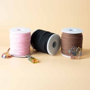 Black faux suede pendant cord on a spool, ideal for jewellery making and crafting.