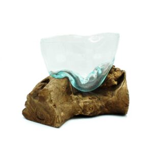 Artfully misshapen molten glass bowl resting on a wooden base.