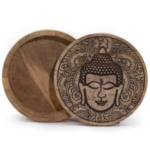 Black engraved Buddha face on a round box, perfect for home decor.