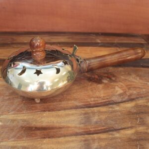 Brass incense butler featuring a pentagram design and wooden handle.