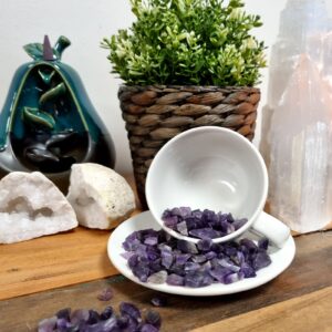 Bulk black tourmaline gemstone chips in a clear container.
