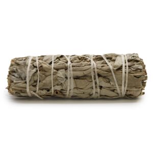 Smudge stick made from white sage and sweetgrass for cleansing spaces.
