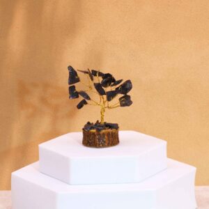 Mini gemstone tree featuring black agate stones on a wooden base.