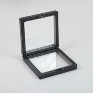 Small black 3D floating frame display showcasing jewellery and collectibles.