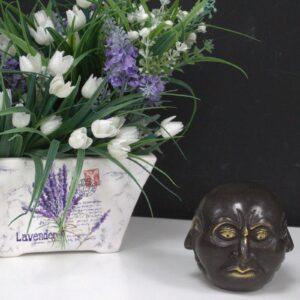 Brass Four Face Buddha ornament for home decor and relaxation.
